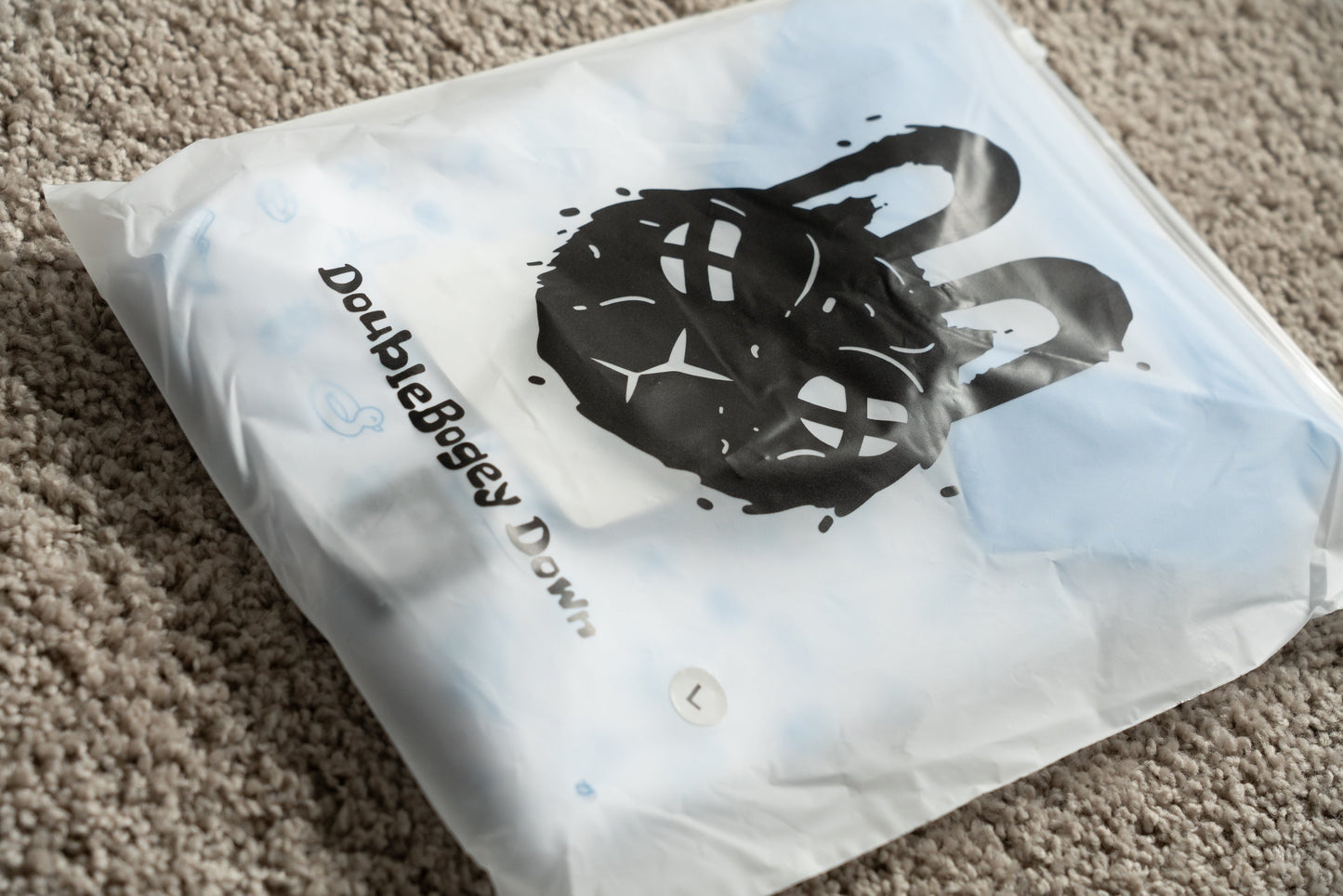 Branded packaging of Fore-Shore Vibes golf polo featuring eco-friendly wrapping and DoubleBogey Down Apparel label