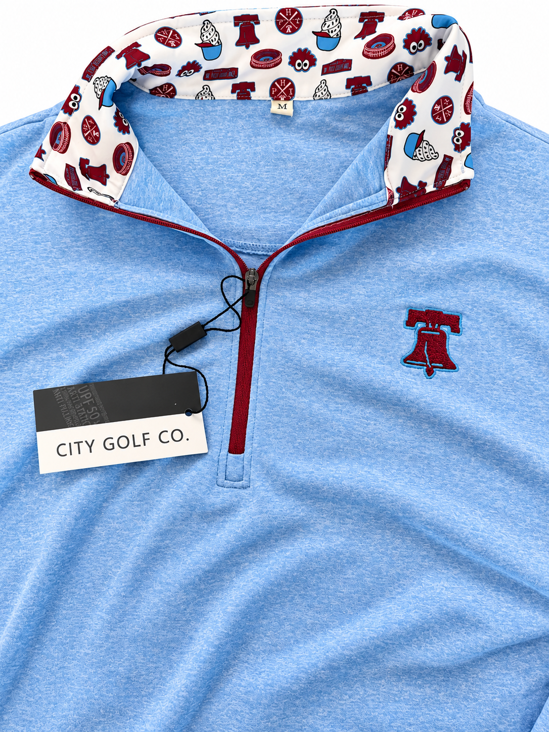 The Pattison Zip Up light blue quarter-zip pullover, with a red zipper, embroidered logo, and sports-print collar lining.
