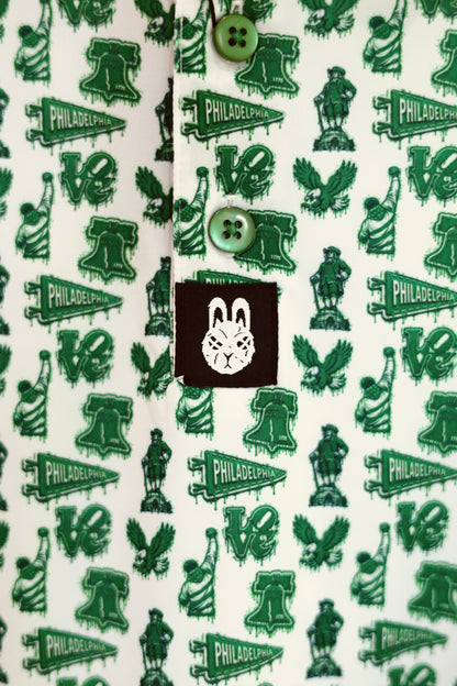 Front detail of The Bleeding Green Polo featuring Kelly green buttons, all-over Philadelphia-inspired graphics, and City Golf Co. logo tag.