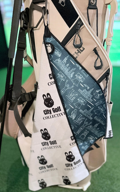 The Philly Heritage Golf Towel showing its double-sided design with Philadelphia artwork and City Golf Collective branding.