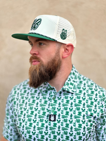 Model wearing a white and green Philadelphia-themed performance golf polo with matching rope hat featuring city-inspired icons