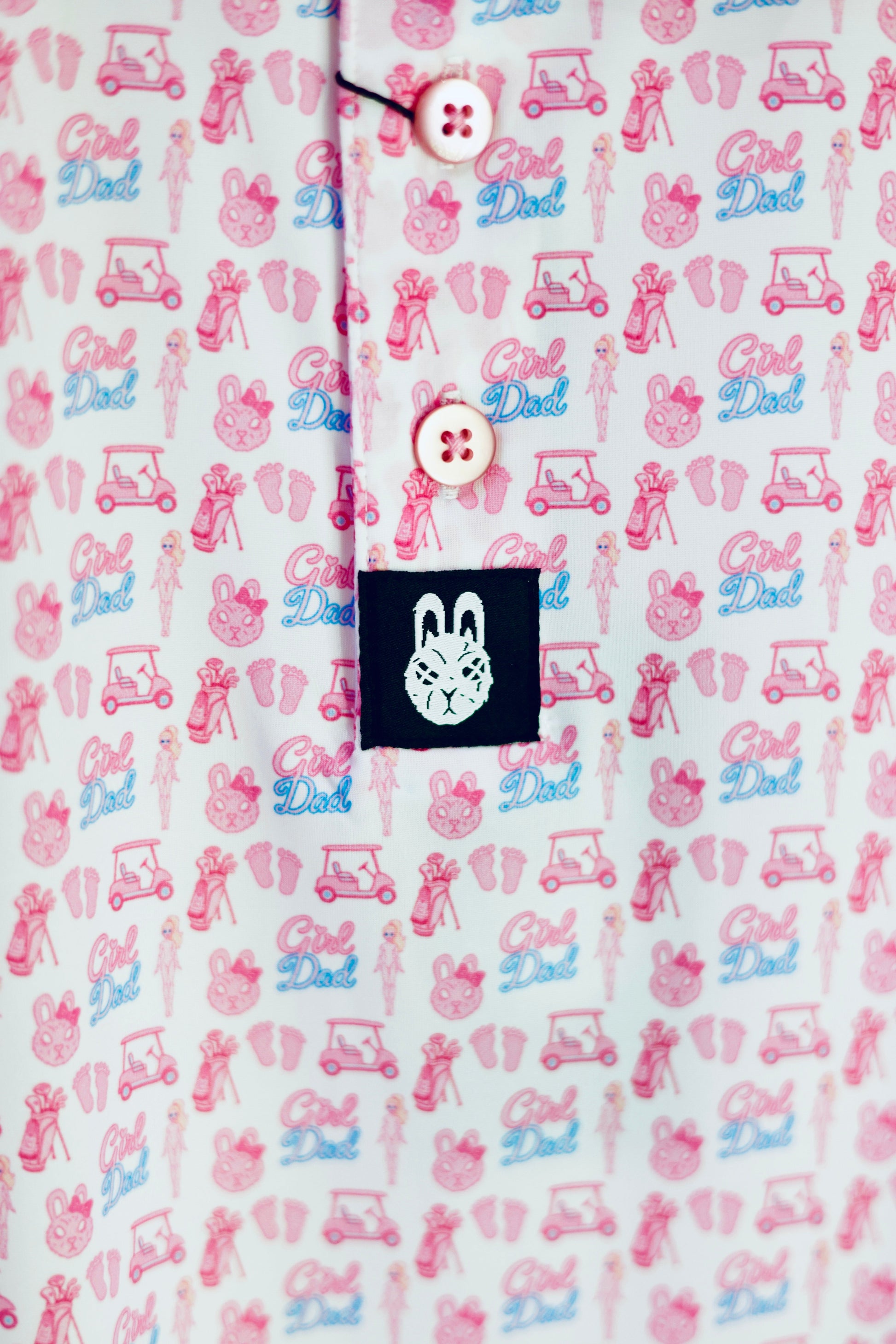 Close-up of The Girl Dad Polo showcasing the playful all-over print, premium buttons, and City Golf Co. logo tag.
