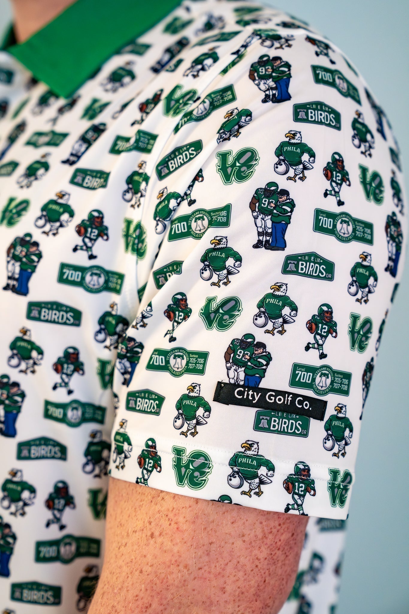 Side view of The 700 Level Classic Polo by City Golf Collective highlighting fit, sleeve detail, and tailored silhouette