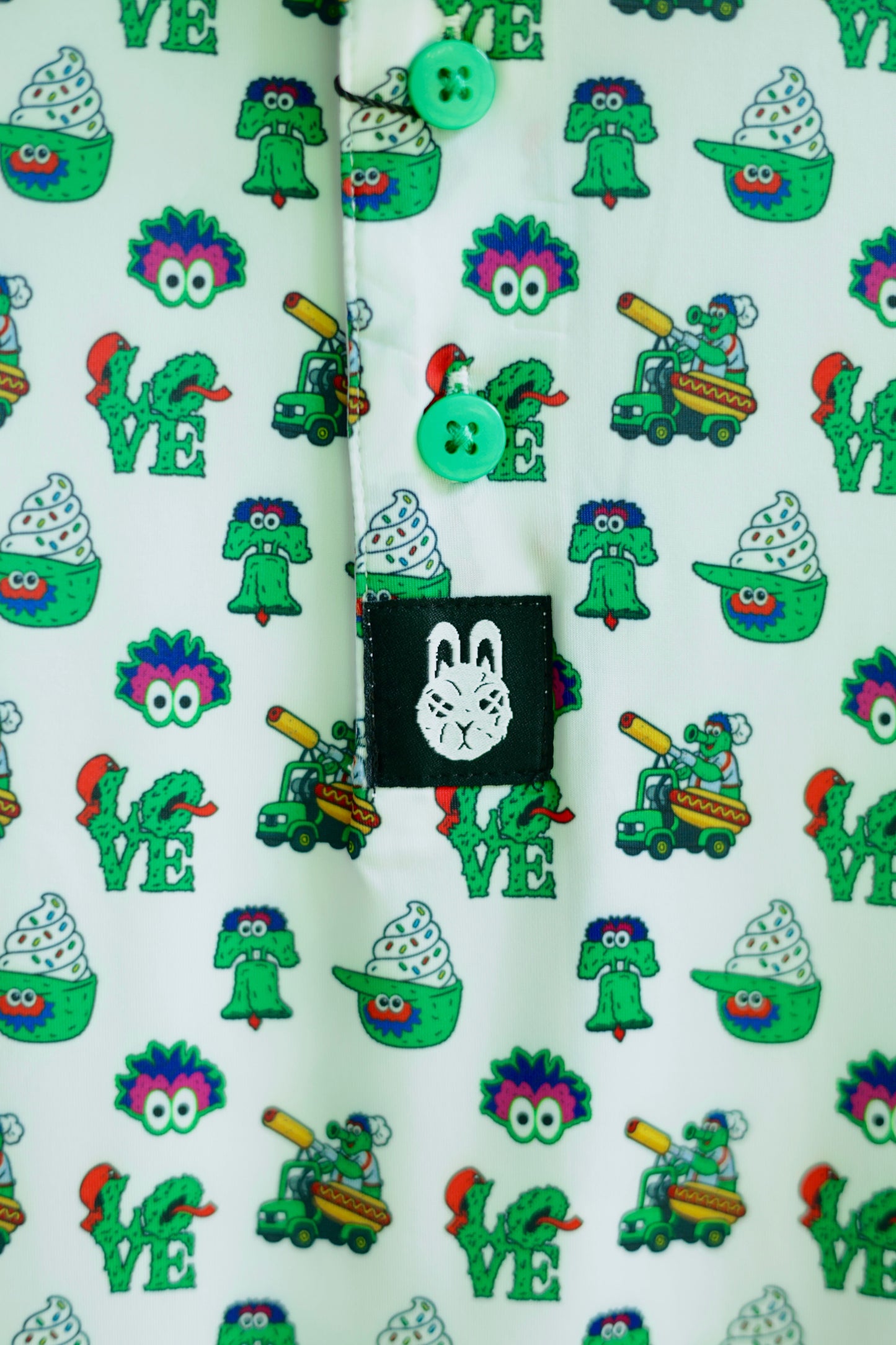 Close-up of The Green Menace Polo showcasing detailed Philadelphia-inspired graphics, including green mascot artwork, baseball-themed icons, and premium sublimated print.