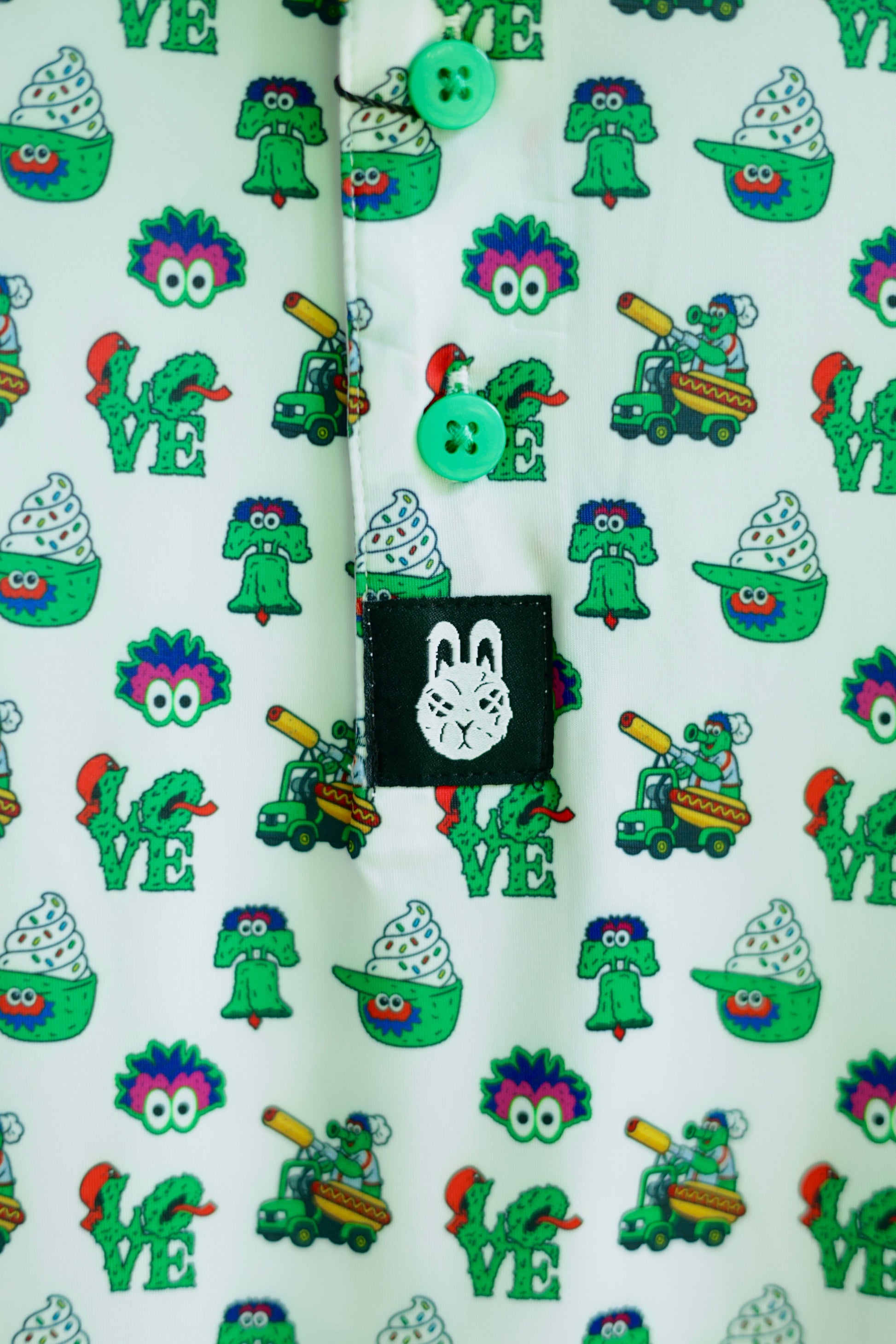 Close-up of The Green Menace Polo showcasing detailed Philadelphia-inspired graphics, including green mascot artwork, baseball-themed icons, and premium sublimated print.