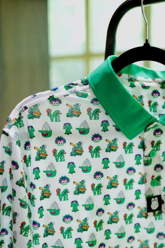 Close-up of The Green Menace Polo featuring custom green buttons, premium woven logo tag, and colorful Philadelphia-inspired mascot pattern on moisture-wicking fabric.