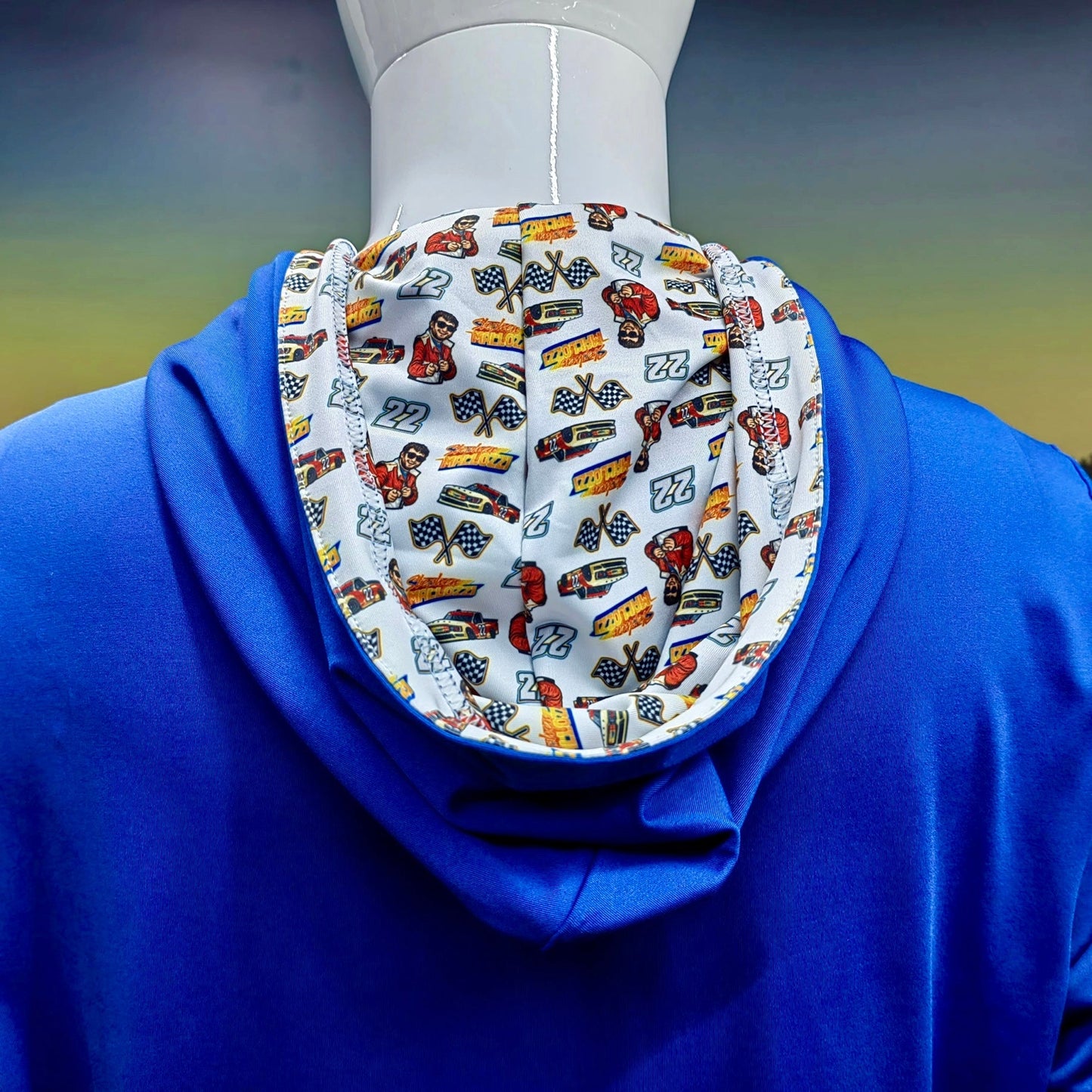City Golf Collective Mallozzi Motors Polo full back view on mannequin featuring blue performance fabric and racing print inside hood detail