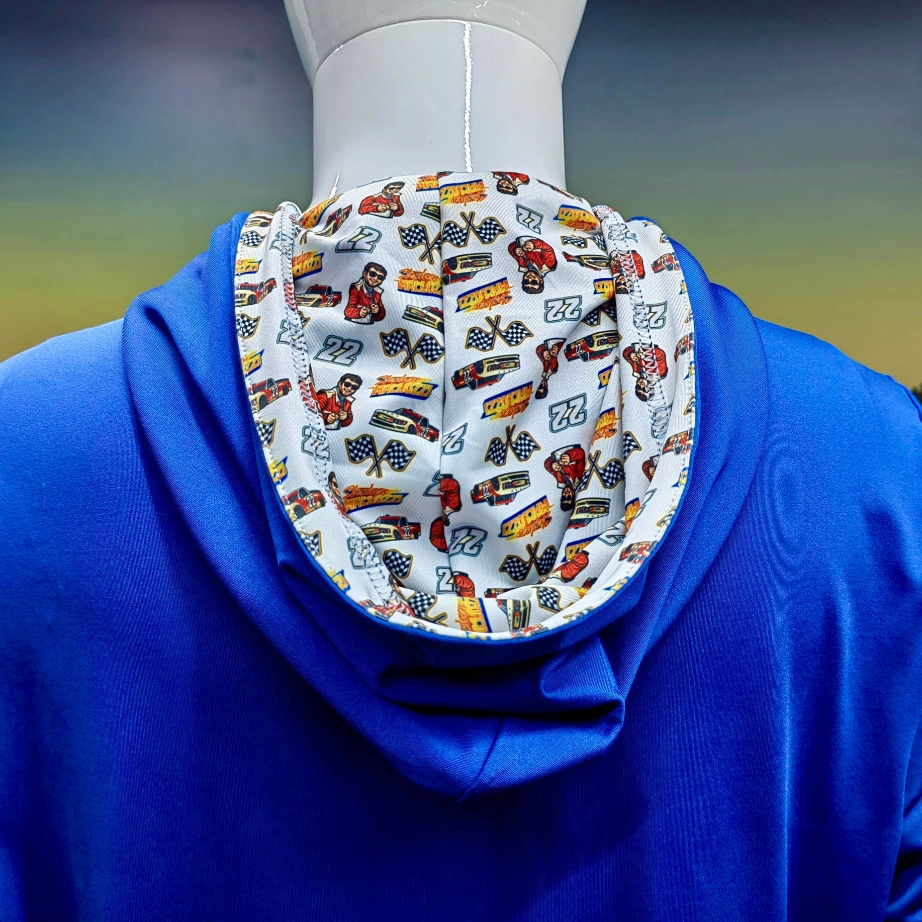 City Golf Collective Mallozzi Motors Polo full back view on mannequin featuring blue performance fabric and racing print inside hood detail
