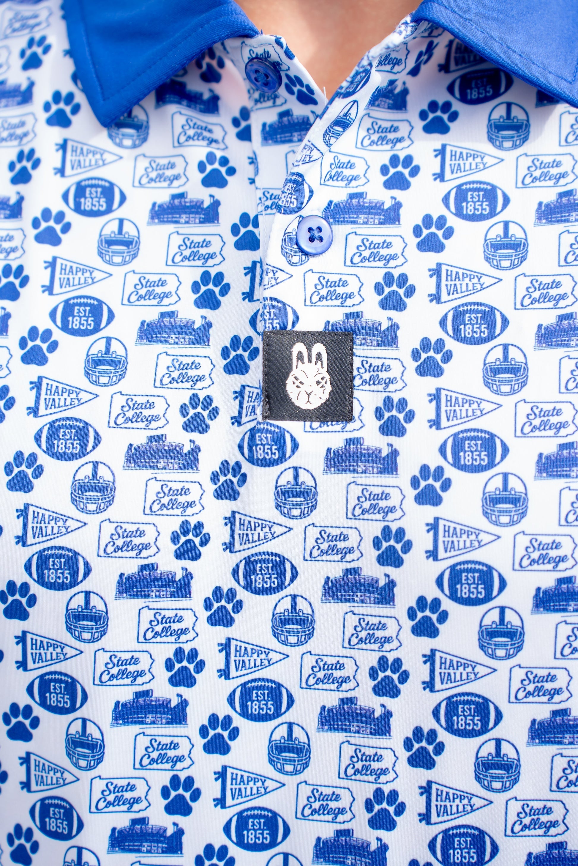 Close-up of the Saturdays in Happy Valley Penn State inspired golf polo by City Golf Collective showing fabric and logo.