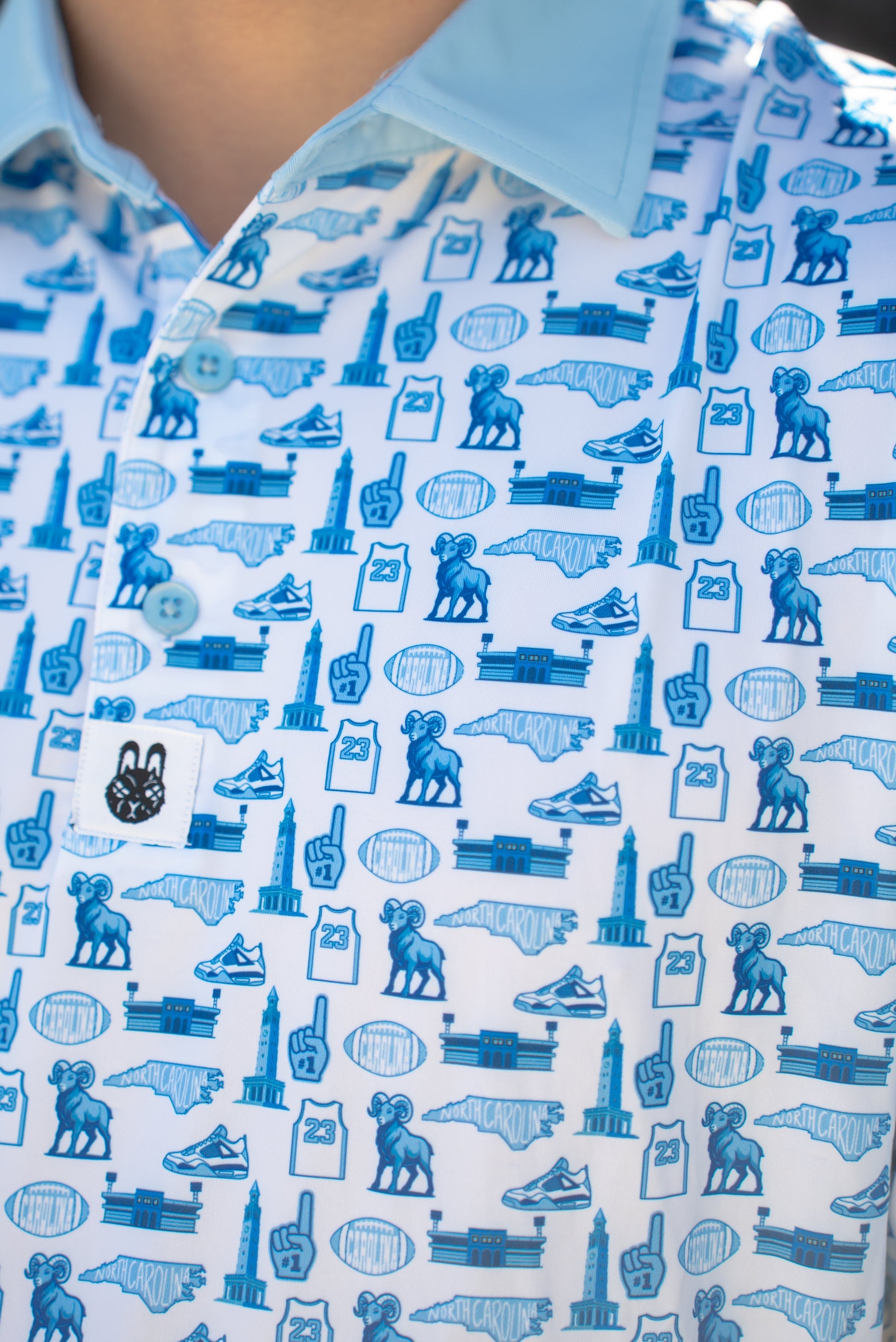 Close-up of the Chapel Hill Hangtime UNC men’s golf polo showing Carolina blue detailing by City Golf Collective