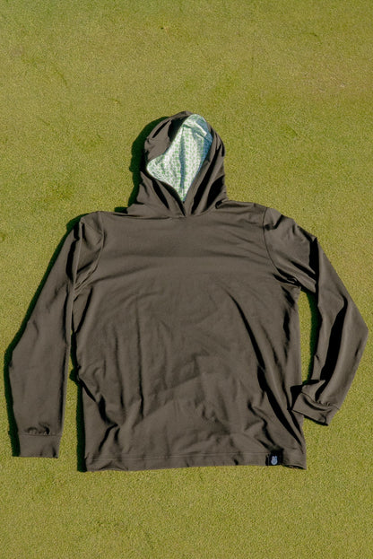 Birds & Hoodies golf hoodie by City Golf Collective laid out on a golf putting green for a clean lifestyle shot.