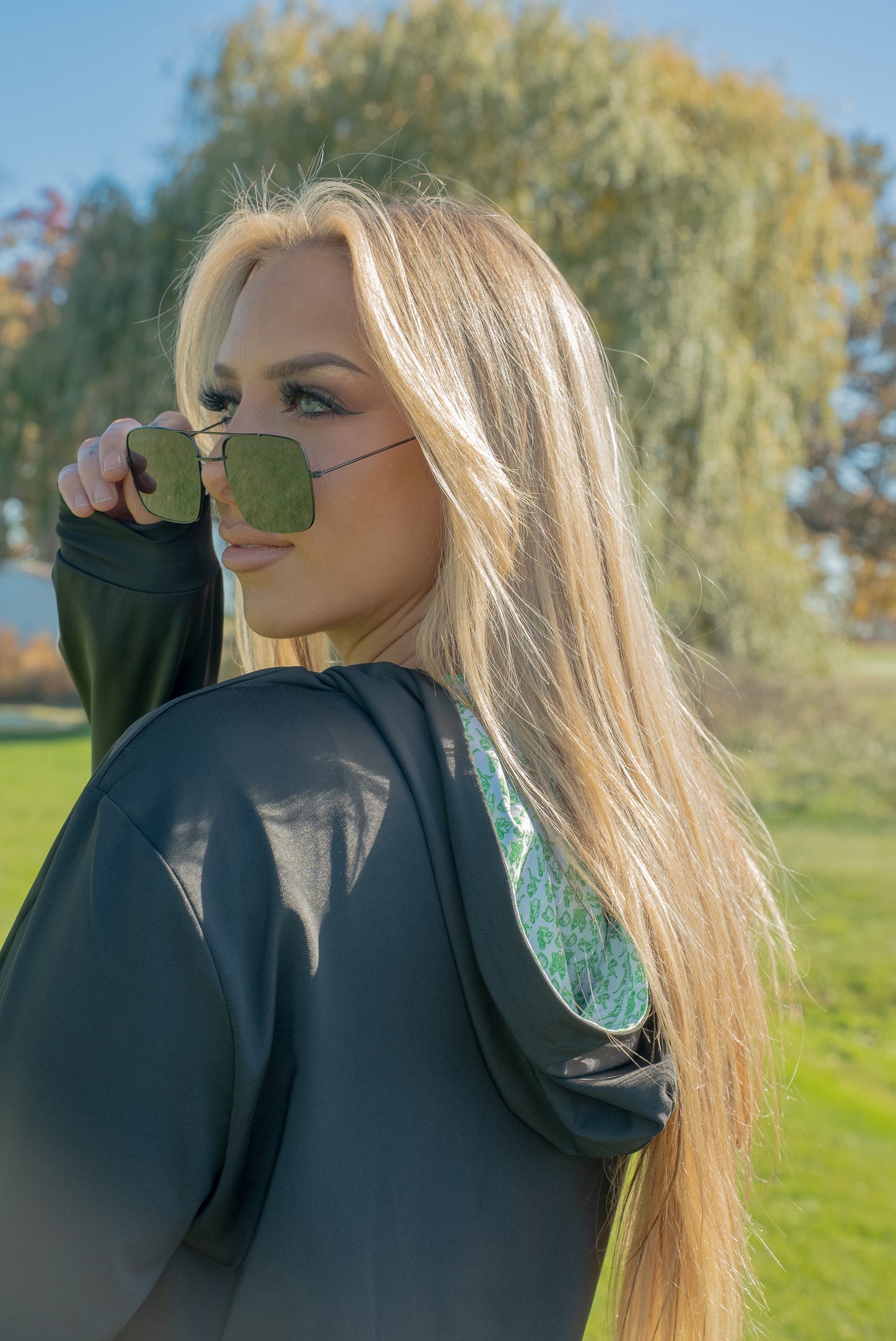 Woman posing in the Birds & Hoodies Philly golf hoodie by City Golf Collective, showing fit and style.