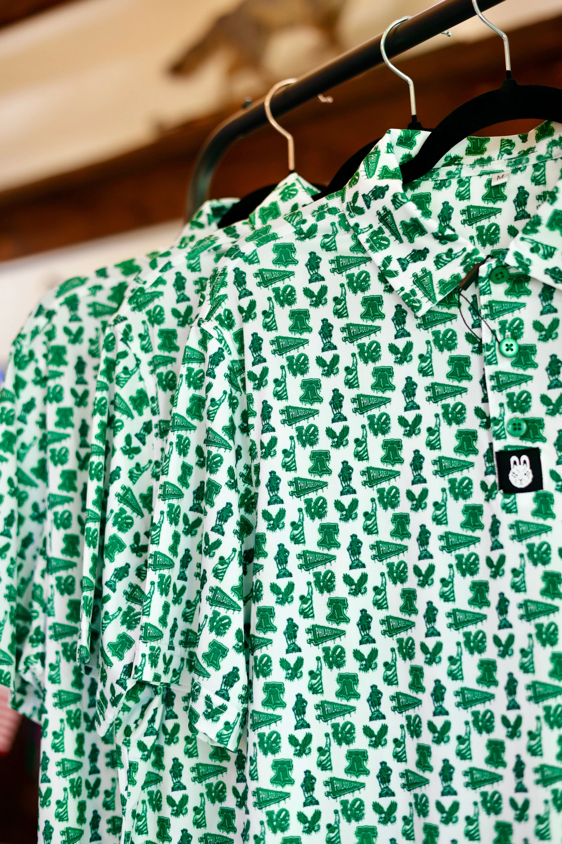 The Bleeding Green Polo featuring an all-over Philadelphia-inspired Kelly green print, lightweight performance fabric, and classic golf polo styling.