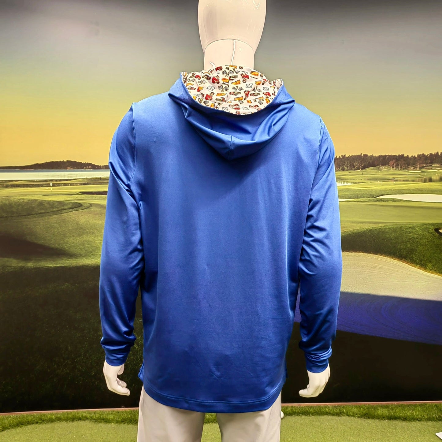 City Golf Collective Mallozzi Motors Polo close up of hood showing detailed racing pattern with cars flags and driver graphics on blue fabric