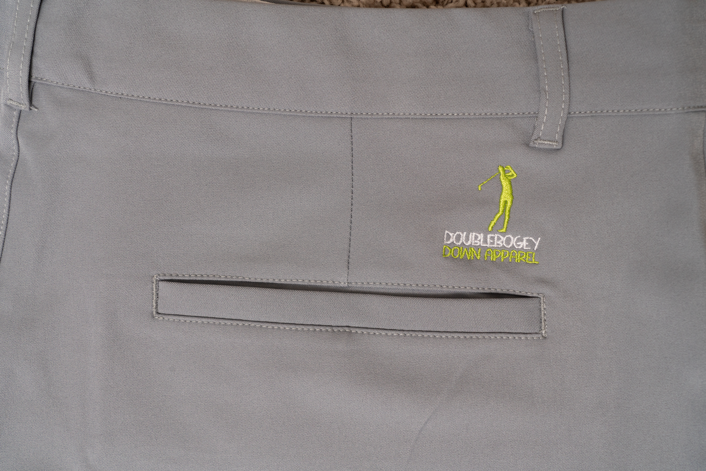 Back detail of The Fairway Fog golf shorts – smooth gray finish with secure pocket stitching and stretch waistband for flexible movement during play.