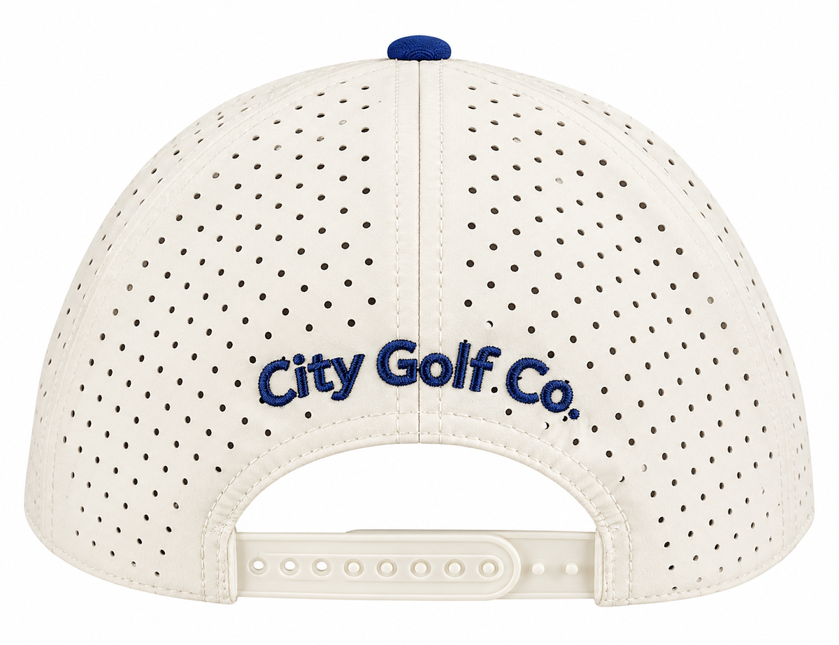 Back view: Cream and navy snapback hat with perforated panels, adjustable closure, and embroidered City Golf Co. branding.