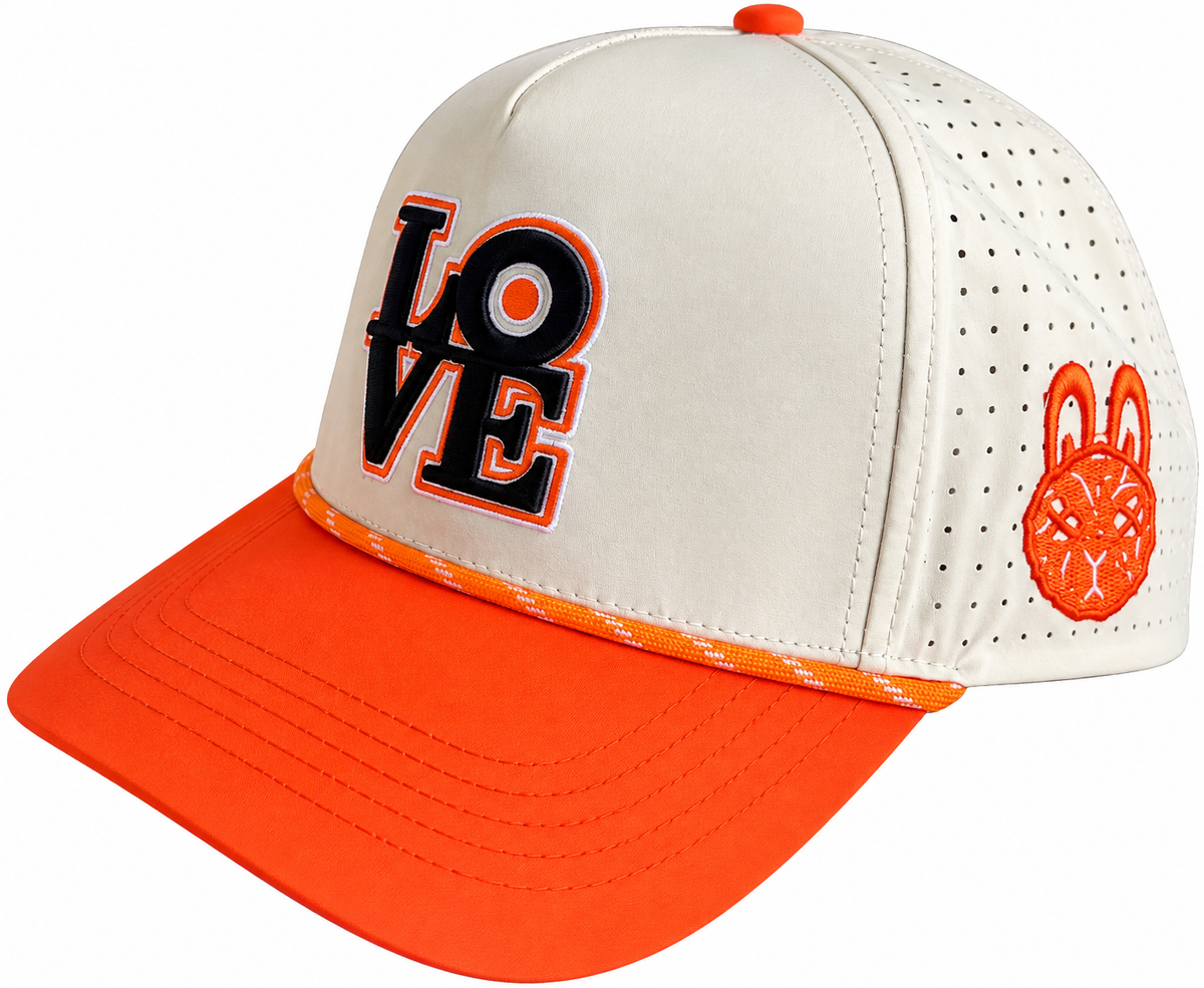 Side view of From Broad Street with Love Hat featuring cream perforated panels, orange brim and embroidered LOVE design