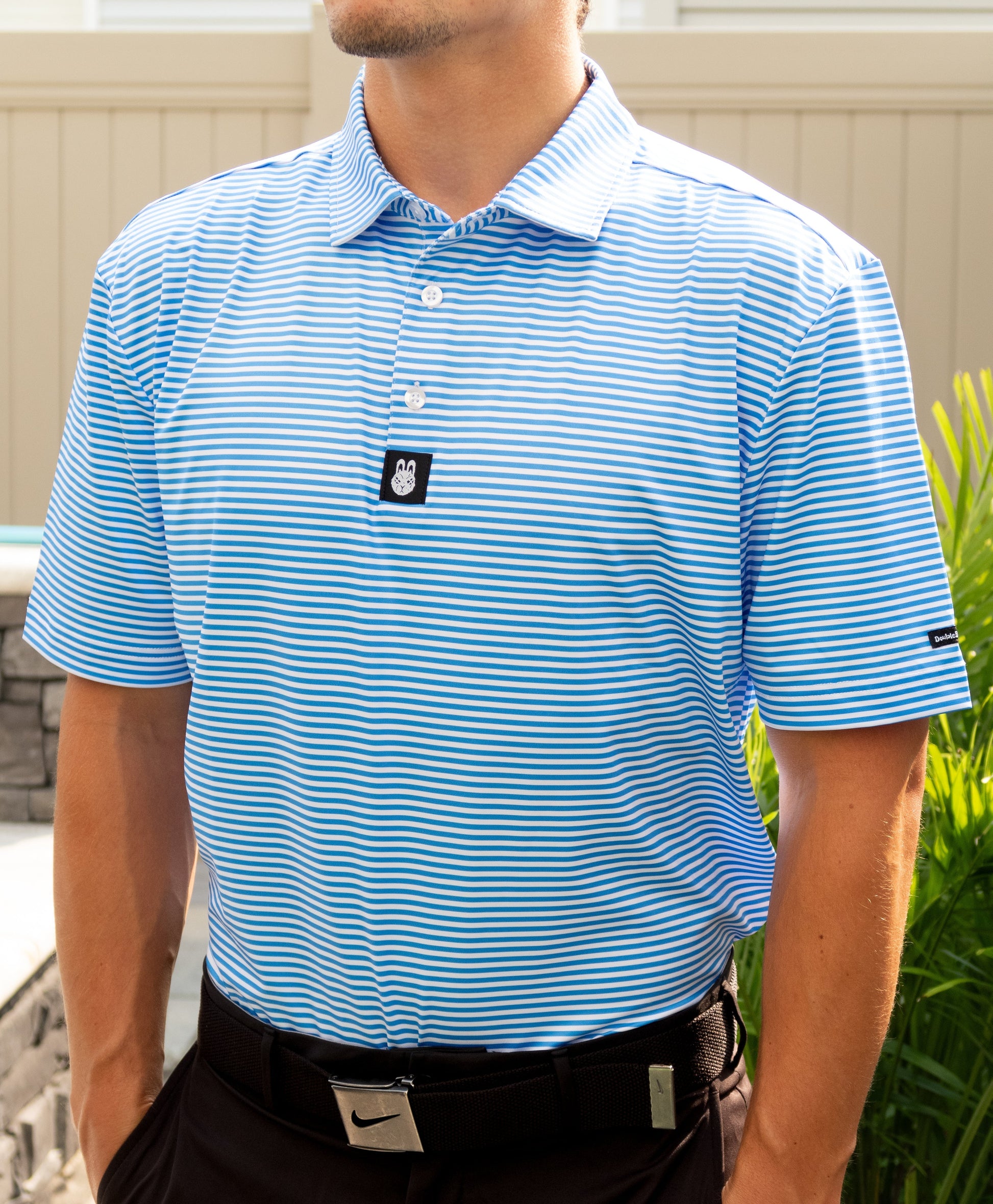 Alternate front angle of The Captain Ron blue and white striped men’s golf polo by City Golf Collective showing collar detail.